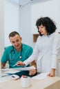 Expert Nurse Explaining Medical Test Results to Doctor in Hospital