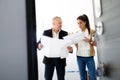 Teamwork With Boss And Assistant Looking At Plans In Building Royalty Free Stock Photo