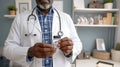 Expert physician carefully examines a bottle of life-saving pills. Royalty Free Stock Photo