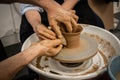 Expert potter teach a woman to work on potter wheel Royalty Free Stock Photo
