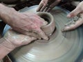 The Hands are sculpting the clay into the desired shape. Is one of the process of making pottery