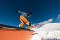 Expert snowboarder balancing and executing tricks on the wallride. Royalty Free Stock Photo