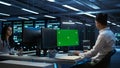 Expert updating server room systems using green screen computer Royalty Free Stock Photo