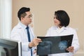 Expertise doctor planning treatment for medical concept. Two asian doctor looking at film x-ray head of patient and discussing