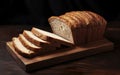 Expertly sliced fresh bread on a wooden cutting board. Royalty Free Stock Photo