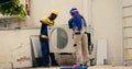 Experts working on air conditioner Royalty Free Stock Photo