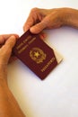 An expired passport in the hands of an old woman