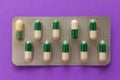 Expired white and green capsules in medicine box. Pills over lav Royalty Free Stock Photo