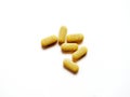 Expired yellow tablets vitamin C medicine on white background. Dangerous pills to use