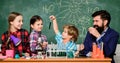 Explaining chemistry to kids. Fascinating chemistry lesson. Man bearded teacher and pupils with test tubes in classroom