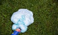 An exploded cylinder with construction foam on the grass. Balloon defect, close-up