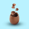 Exploded milk chocolate egg on light blue background Royalty Free Stock Photo
