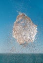 Exploded water, abstract water shape in the air over the sea with blue sky background Royalty Free Stock Photo