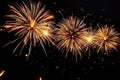 bright golden fireworks exploding in the night sky creating a festive and celebratory atmosphere with sparkling light trails Royalty Free Stock Photo
