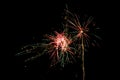 Exploding fireworks rocket for the New Year celebration against a black night sky with copy space Royalty Free Stock Photo
