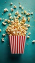 Exploding red popcorn box on a teal, kernels mid-air create a sense of excitement for movie time Royalty Free Stock Photo
