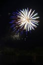 Exploding round white and blue fireworks in black night sky with copy space Royalty Free Stock Photo