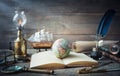 Exploration and nautical theme grunge background. Globe, telescope, divider, old coins, shell, map, book, hourglass, quill pen on Royalty Free Stock Photo