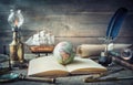 Exploration and nautical theme grunge background. Globe, telescope, divider, old coins, shell, map, book, hourglass, quill pen on Royalty Free Stock Photo