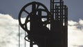 Exploratory pit silhouette against sky with clouds