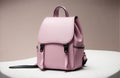 Explore the Beauty of a Pink Women\'s Handbag Backpack on a Trendy Dark Pink Studio Backgroun.