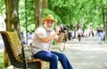 Explore city. Tourism hobby. Tourist concept. Travel and tourism. Photographer sit on bench in park. Capturing spring