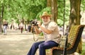 Explore city. Tourism hobby. Tourist concept. Travel and tourism. Photographer sit on bench in park. Capturing spring