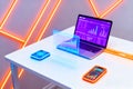 Futuristic digital marketing setup with laptop and devices glowing with neon lights Royalty Free Stock Photo