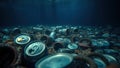 Calm but eerie underwater environment with floating plastic lids and aluminum cans Royalty Free Stock Photo