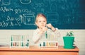 Explore and investigate. School lesson. Girl cute school pupil play with test tubes and colorful liquids. School Royalty Free Stock Photo