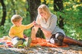 Explore nature together. Mom and kid boy relaxing while hiking in forest. Family picnic. Mother pretty woman and little