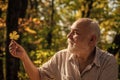 Explore world around. Pensioner hiking in forest on sunny autumn day. Man enjoy autumn nature. Old man collect leaves Royalty Free Stock Photo