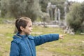 Explored boy shows his destination with his finger