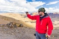 Tourist man adventurer backpacker taking picture mountain peak Peru