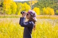 Explorer binocuar kid girl in yellow autumn nature