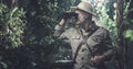 Explorer with binoculars in the jungle Royalty Free Stock Photo