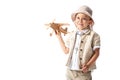 Explorer boy in glasses and hat holding wooden toy plane isolated on white