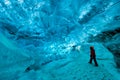 Explorer inside an ice cave, vatnajokull national park, Iceland Royalty Free Stock Photo