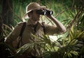 Explorer in the jungle with binoculars Royalty Free Stock Photo