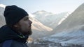 Explorer man look in winter in a snowy mountain breathing fresh air