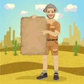 Explorer young man with safari hat holding treasure map in desert