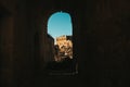 Exploring the Abandoned Beauty of an Italian Palazzo in Craco Through an Old Brick Tunnel with a Stunning Blue Sky View Royalty Free Stock Photo