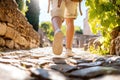Exploring ancient ruins on sunny day: traveler walking on cobblestone path Royalty Free Stock Photo