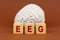 Exploring brain function through an electroencephalogram with creative blocks representing EEG in a serene atmosphere