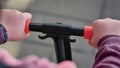 Exploring the city on a scooter: child& x27;s hands on the handlebar Royalty Free Stock Photo