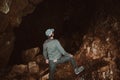 Exploring the depths of a Himalayan cave in Uttarakhand, India, a man with a head torch, capturing the spirit of adventure and