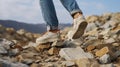 Exploring Earth\'s Majesty: Legs Poised on Mountain Stones. Generative AI Royalty Free Stock Photo