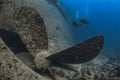 Exploring History: Divers at the Thistlegorm Wreck Propeller in the Red Sea Royalty Free Stock Photo