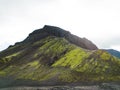 Exploring Iceland highlands in autumn, volcanic rock formations covered in green moss
