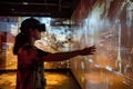 Exploring Immersive Virtual Reality, A Person Interacts with a Futuristic Interactive Display Using VR Headset, Nav